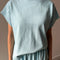model wearing sky blue cotton tee with slight cap sleeves and matching cotton balloon pants