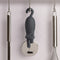 black cat pizza cutter hanging with kitchen utensils