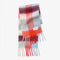 folded thick scarf with various shades of blue and red checkers and fringe