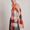 side view of model wearing thick scarf with various shades of blue and red checkers and fringe