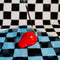 small strawberry shaped incense holder with a burning incense inside