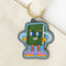 enamel keychain with green book man with arms, face and legs on bag