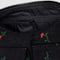 up close of interior zipper of black small cargo bag with two front patch pockets and red painted wildflower print