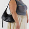 model carrying black leather medium crescent bag