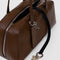 black key leash of medium brown recycled dome bowler bag with silver charm clasp