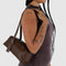 model carrying brown small dome recycled leather bowler bag with silver charm clasp
