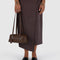model holding brown small dome recycled leather bowler bag with silver charm clasp