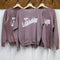 hanging rosewood sweatshirts with white Bonjour De La Bibliothèque across the front