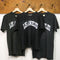 three hanging black upcycled tees with white LOS ANGELES across the front