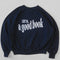 navy sweatshirt with white 'LOST IN... GOOD BOOK' across the front