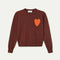 brown sweater with textured orange heart on the left bust
