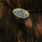 up close of model wearing cornflower 'pyrex inspired' circle hair clip