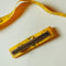 back view of yellow measuring tape bow hair clip