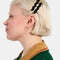 model wearing set of two black wavy hair clips