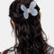 model wearing 3D clear butterfly hair claw with hair half up half down