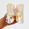 model opening peach, pale yellow and pale purple translucent hair claw