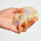 model holding peach, pale yellow and pale purple translucent hair claw