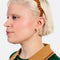 model wearing brown and white plaid wavy headband