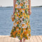 model wearing yellow and white mixed fruit tiered maxi skirt with tie waist