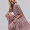 sideview of model wearing pink floral drop waist midi dress with periwinkle trim on the neckline and puff sleeves