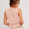 back view of model wearing peach button front tank with floral eyelets and flutter sleeves