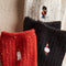 set of three pair of speckled crew socks: white socks with nutcracker, black socks with ornament and red socks with candle