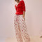 model wearing white relaxed fit PJ pants with different shaped red dots