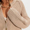 up close of model wearing tan cropped thick knit cardigan