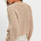 back view of model wearing tan cropped thick knit cardigan