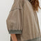 side view of model wearing brown oversized short sleeve sweatshirt with olive green trim