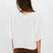 back view of model wearing white tee with raw edge detail and bat wing sleeves
