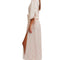 side view of model wearing cream maxi robe with elastic tie waist and red ditsy floral print