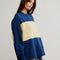 side view of model wearing royal blue and yellow large stripe henley top