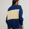 back view of model wearing royal blue and yellow large stripe henley top