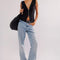 model wearing black ribbed button front tank and jeans