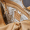 interior of light tan leather purse with several zippered pockets, double handles and crossbody strap