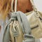 up close of mini washed beige leather purse with several zippered pockets, double handles and crossbody strap