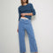 model wearing medium blue denim with a relaxed fit and slight cropped hem
