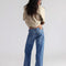 back view of model wearing low rise medium denim wash boyfriend jeans
