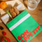 green and cream snack bag with red 'bon appetit' across the front on a table
