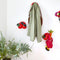 red orange mini wall hook holder hanging on a wall with various items inside