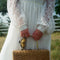 model carrying yellow butterfly vintage lamp inspired hair claw on their handbag