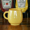 yellow melamine mug on a table with condiments