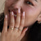 model wearing gold ring with heart shaped locket