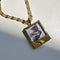gold polaroid photo charm necklace with a cat photo inside
