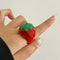 model wearing red strawberry enamel dome ring