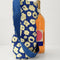 royal blue wine tote with abstract cream floral print next to a bottle