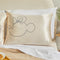 cream silk pillowcase with minnie mouse sketch profile on a bed