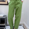 model wearing pistachio green arc pants with side pockets