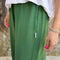 up close of model wearing cotton moss green balloon pants with side pockets